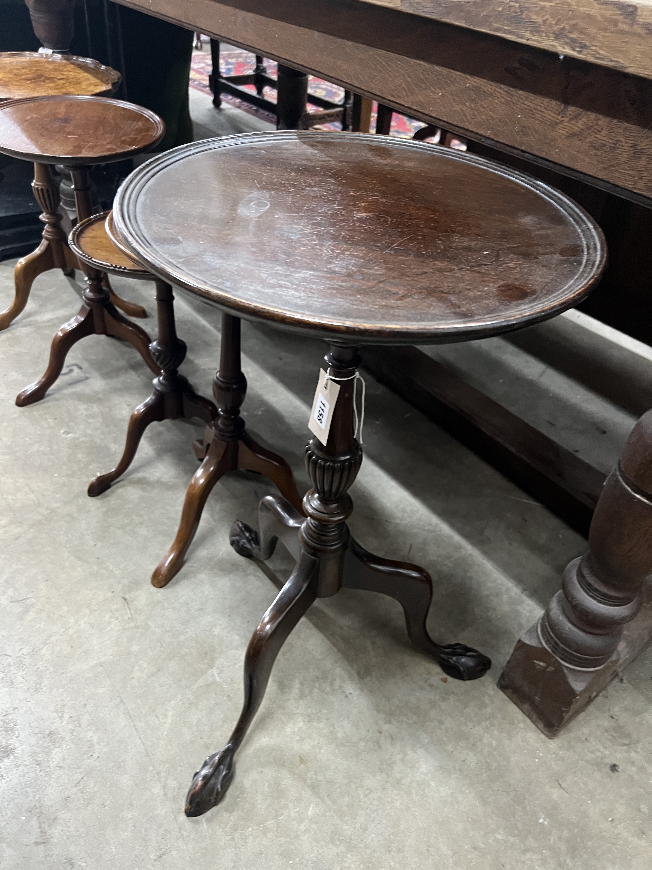 Five early 20th century and later circular mahogany and walnut tripod wine tables, largest diameter 37cm, height 63cm
